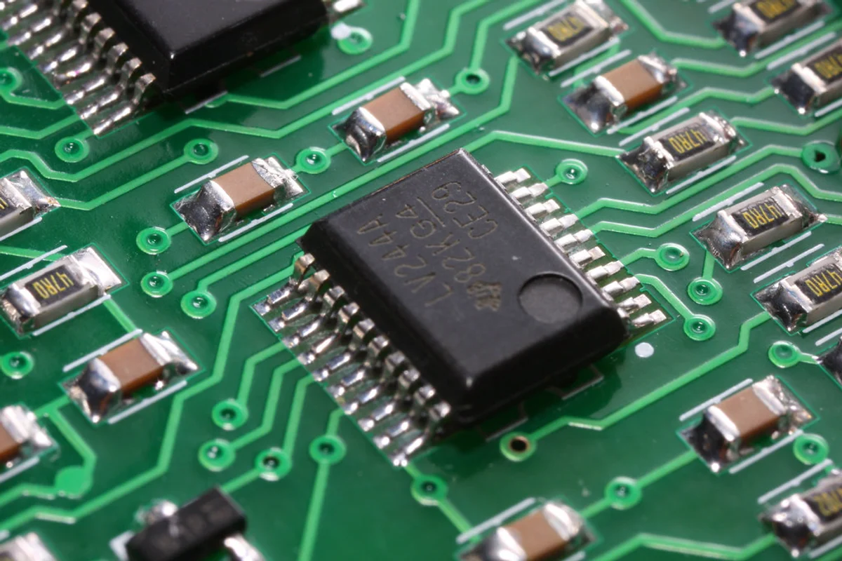 Printed circuit board showing microprocessors, gold-plated contacts, and integrated electronics components.