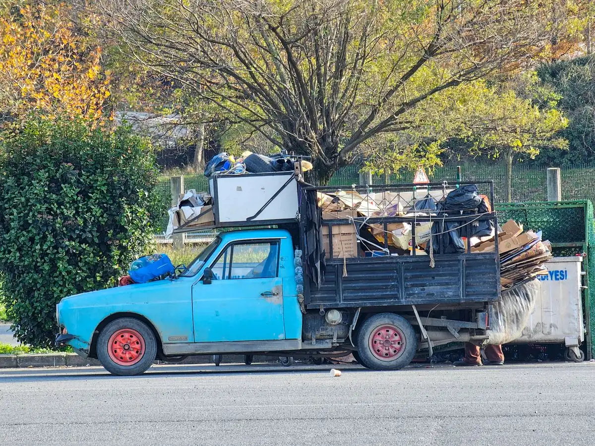 A truck loaded with discarded items and waste ready to be taken away.