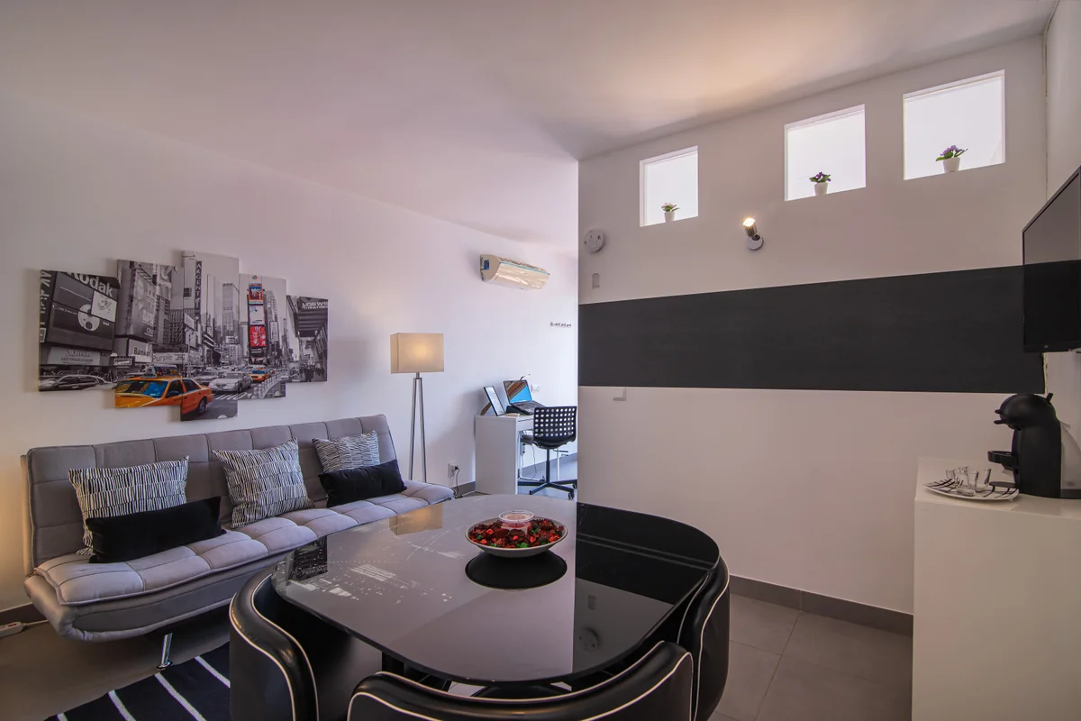 Fully furnished modern apartment living room during an initial room-by-room clearance survey walkthrough.