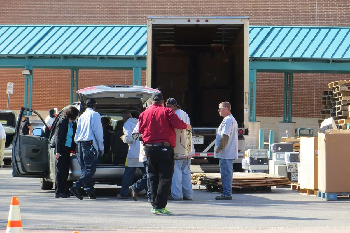 Sorted electronic waste components, hardware, and accessories gathered in collection crates for recycling.