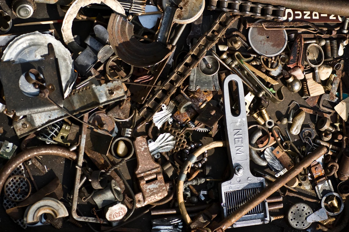 Sorted collection of disassembled scrap metal hardware and components at an industrial recycling facility
