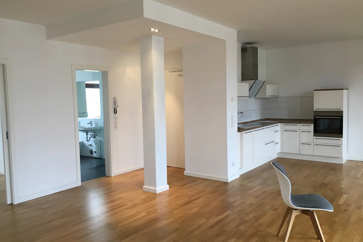 Spotless fitted apartment kitchen with polished surfaces and clean wooden flooring following an end-of-tenancy deep clean.
